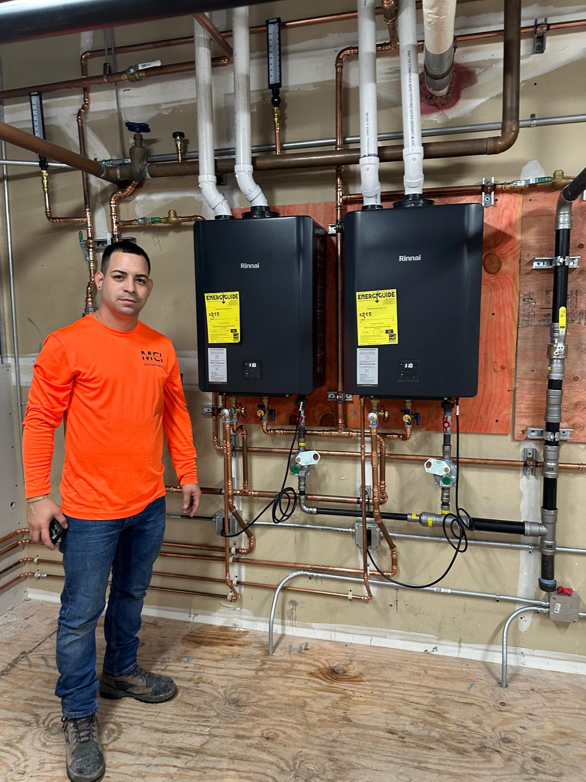 man standing beside a plumbing apparatis