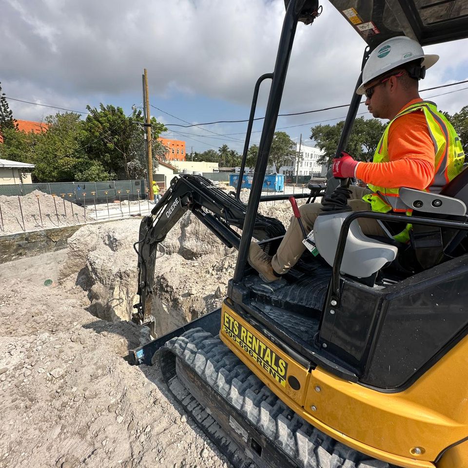 man using an excavator on a worksite